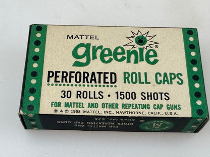 A vintage Mattel Greenie perforated roll caps box, containing 30 rolls of 1500 shots, photographed on a plain white surface.